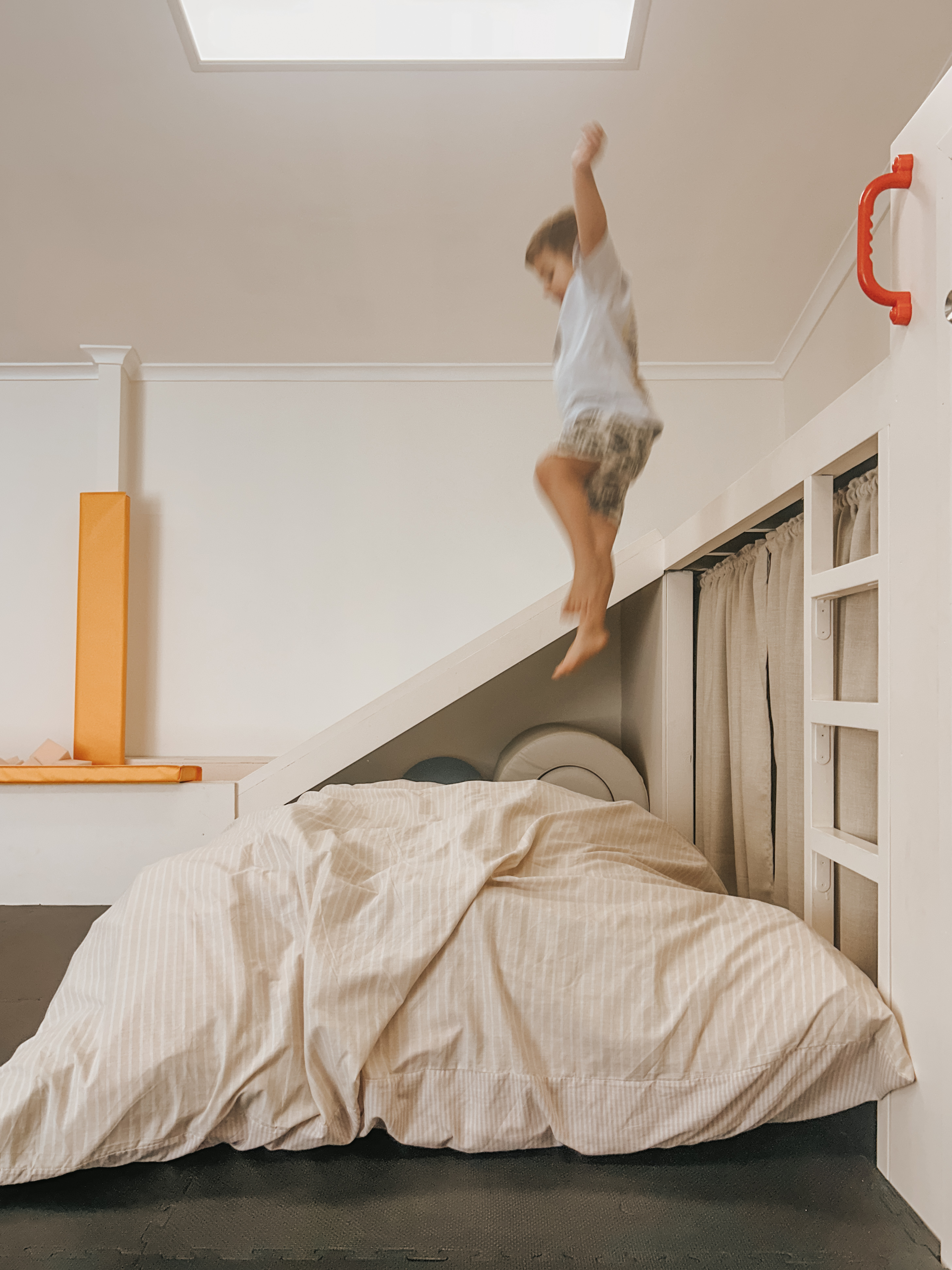 Child jumping onto a crash mat